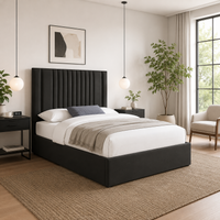 Modern bedroom with a black upholstered bed, white bedding, and decorative elements.